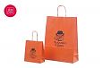 Fotogalerii- oranžid paberkotid, millele trükitud klientide logod oranž paberkott 